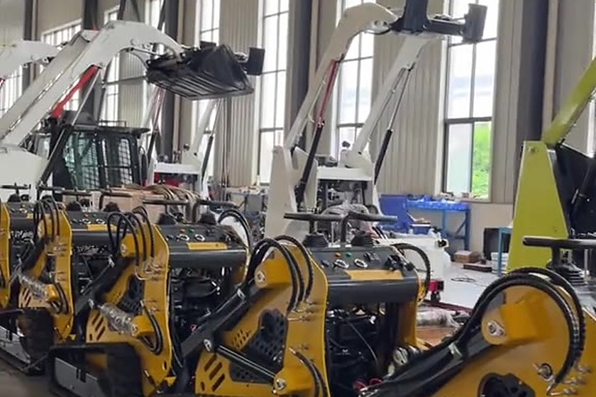 Compact loaders on a bright assembly floor